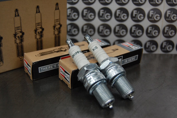 Photo of a pair of Champion N3C spark plugs used in vintage Triumph motorcycles 