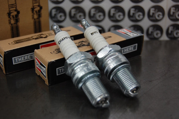 Photo of a pair of Champion N4C spark plugs used in vintage Triumph motorcycles 